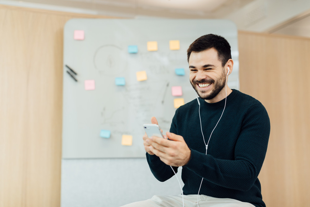 Man smiling and talking to someone on a phone