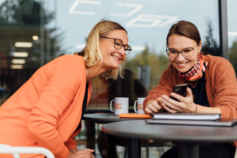 Two women looking at mobile phone